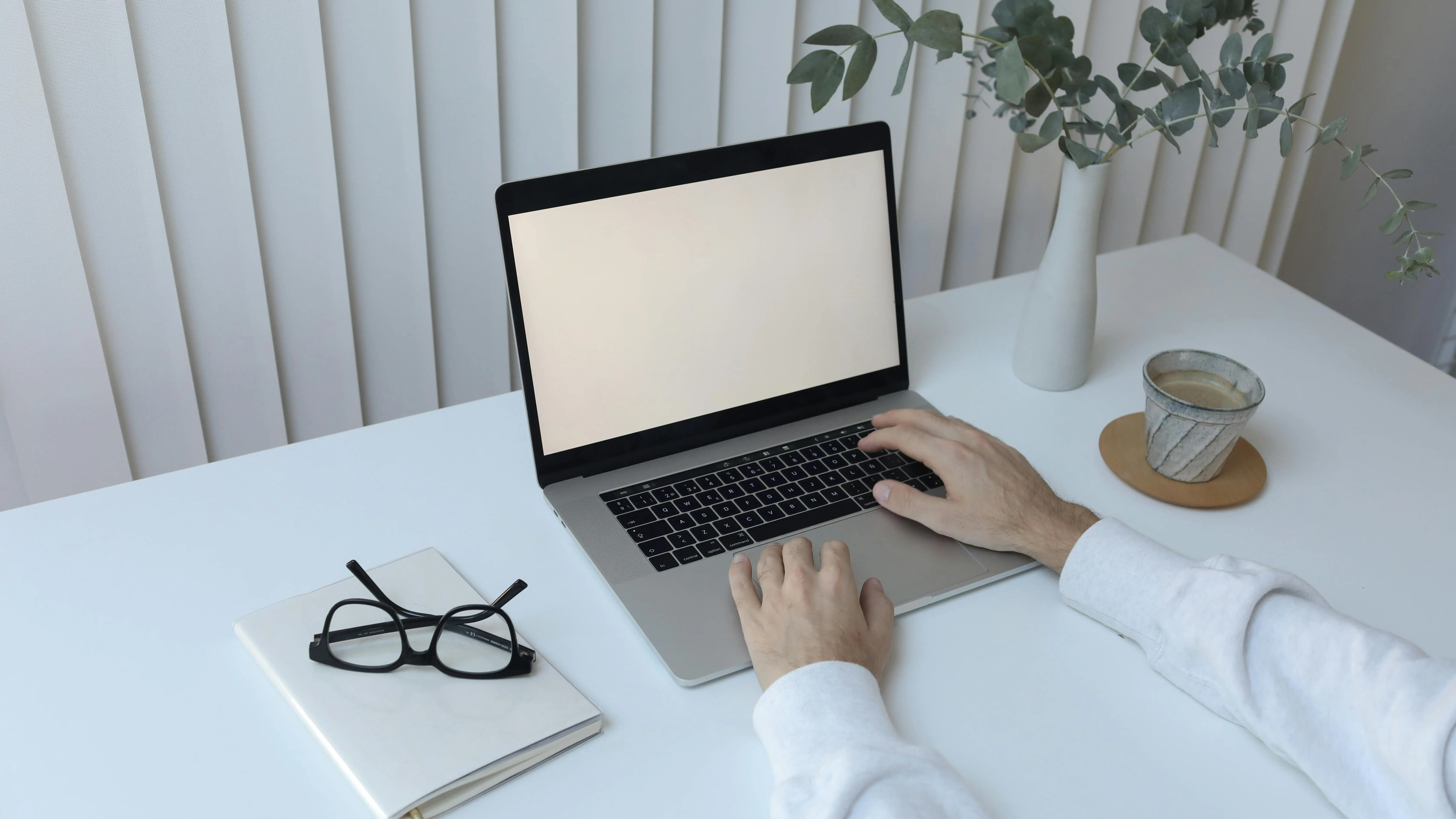 Person typing screenplay on laptop in office