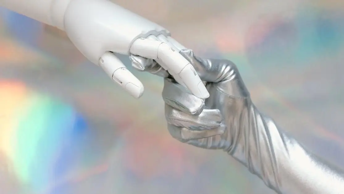 Human and robot hands touching, symbolizing AI screenwriting collaboration.
