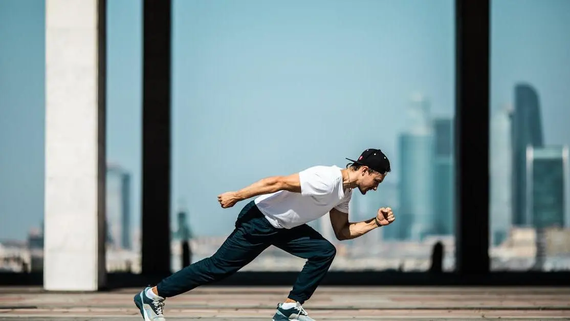 Young man running in city, illustrating lessons from Die Hard for screenwriters.