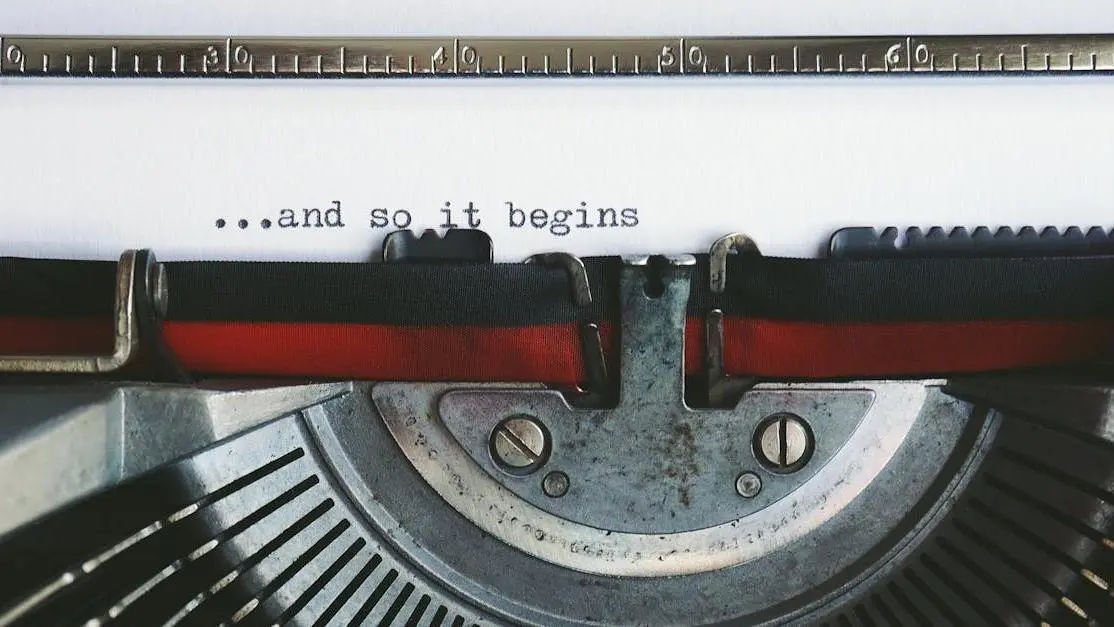 Vintage typewriter with the quote '...and so it begins' related to Tony Gilroy's guidelines on screenwriting