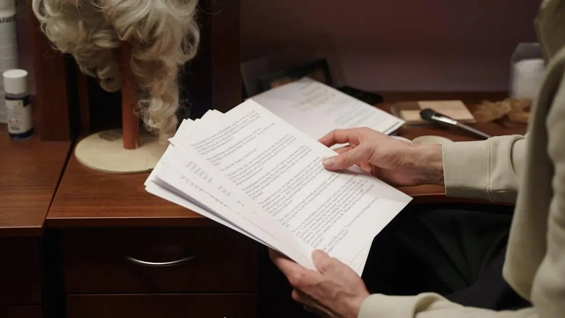 Actor reading script backstage, illustrating screenwriting for actors before theater rehearsal