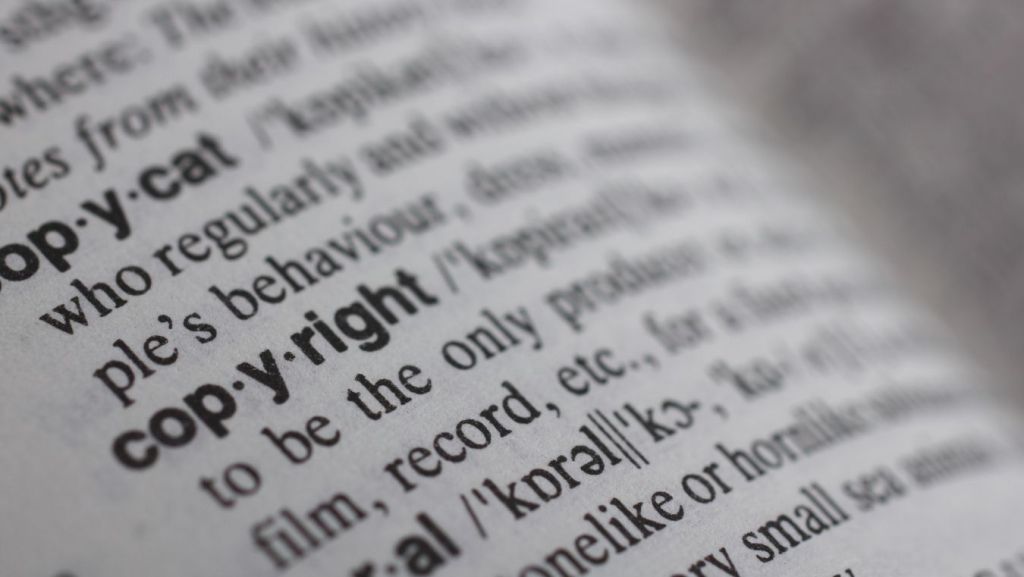 Extreme macro view of the dictionary definition for "copyright," representing intellectual property law and IP protection for screenwriters.