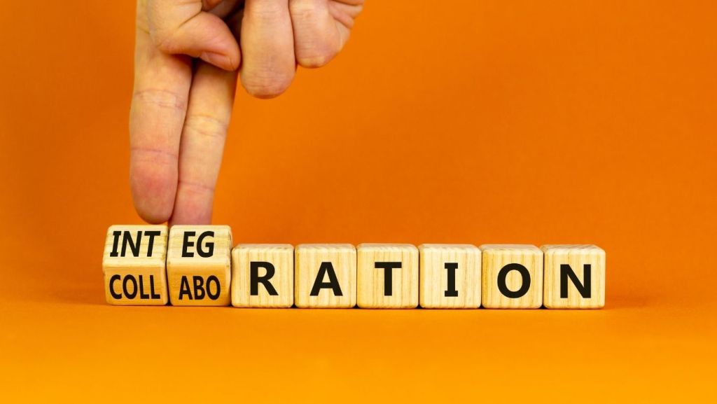 Wooden letter blocks flipping from COLLABORATION to INTEGRATION, symbolizing GL Coverage integrations and connected screenwriting software workflows.