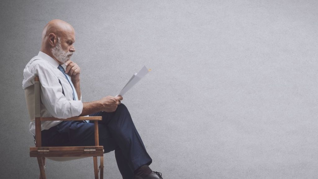 A literary agent or talent manager reviewing a script submission, representing how screenwriters get screenplay representation.