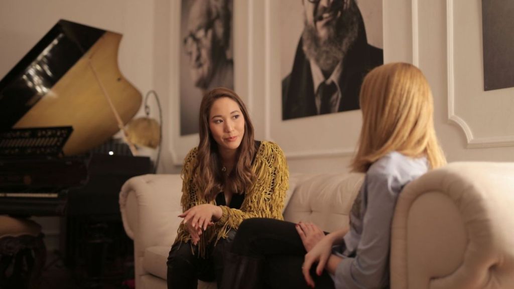 Two women having an engaging couch conversation, illustrating realistic screenplay dialogue that passes reader coverage.