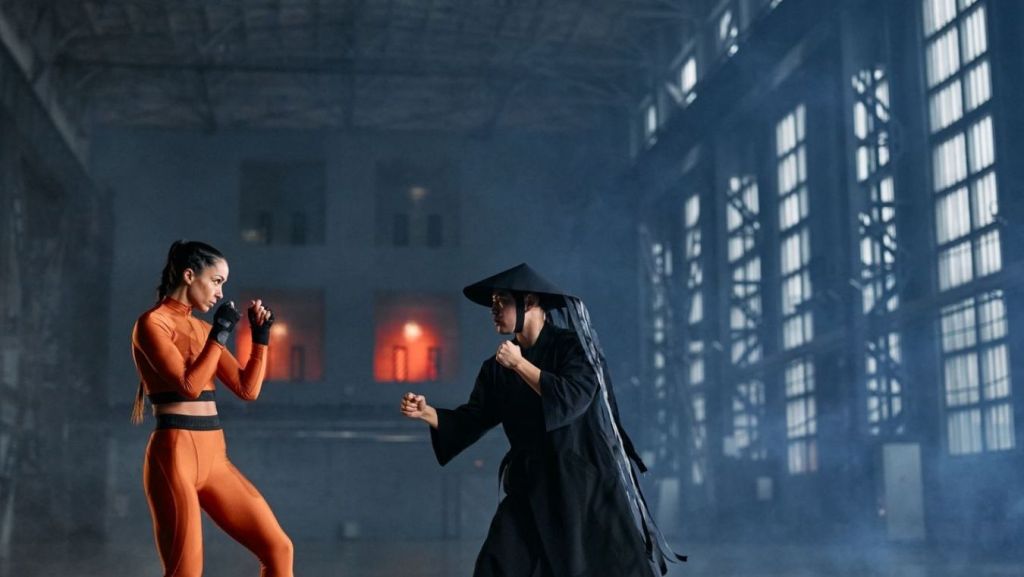 Protagonist and compelling antagonist facing off in a martial arts battle, illustrating character conflict evaluated in script coverage.