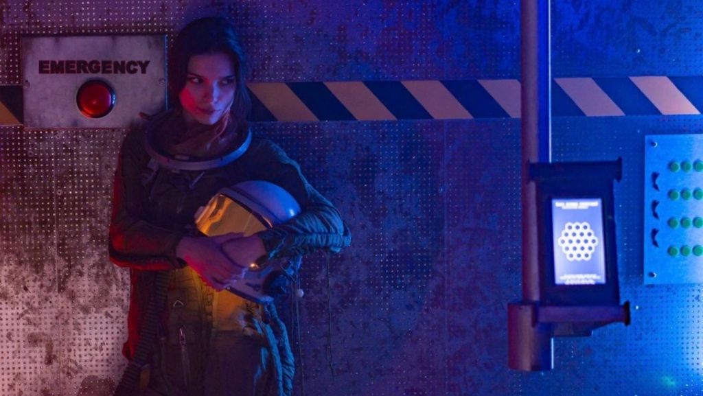 Astronaut holding a helmet near an emergency button in a futuristic hallway, illustrating sci-fi screenplay coverage and worldbuilding evaluation.